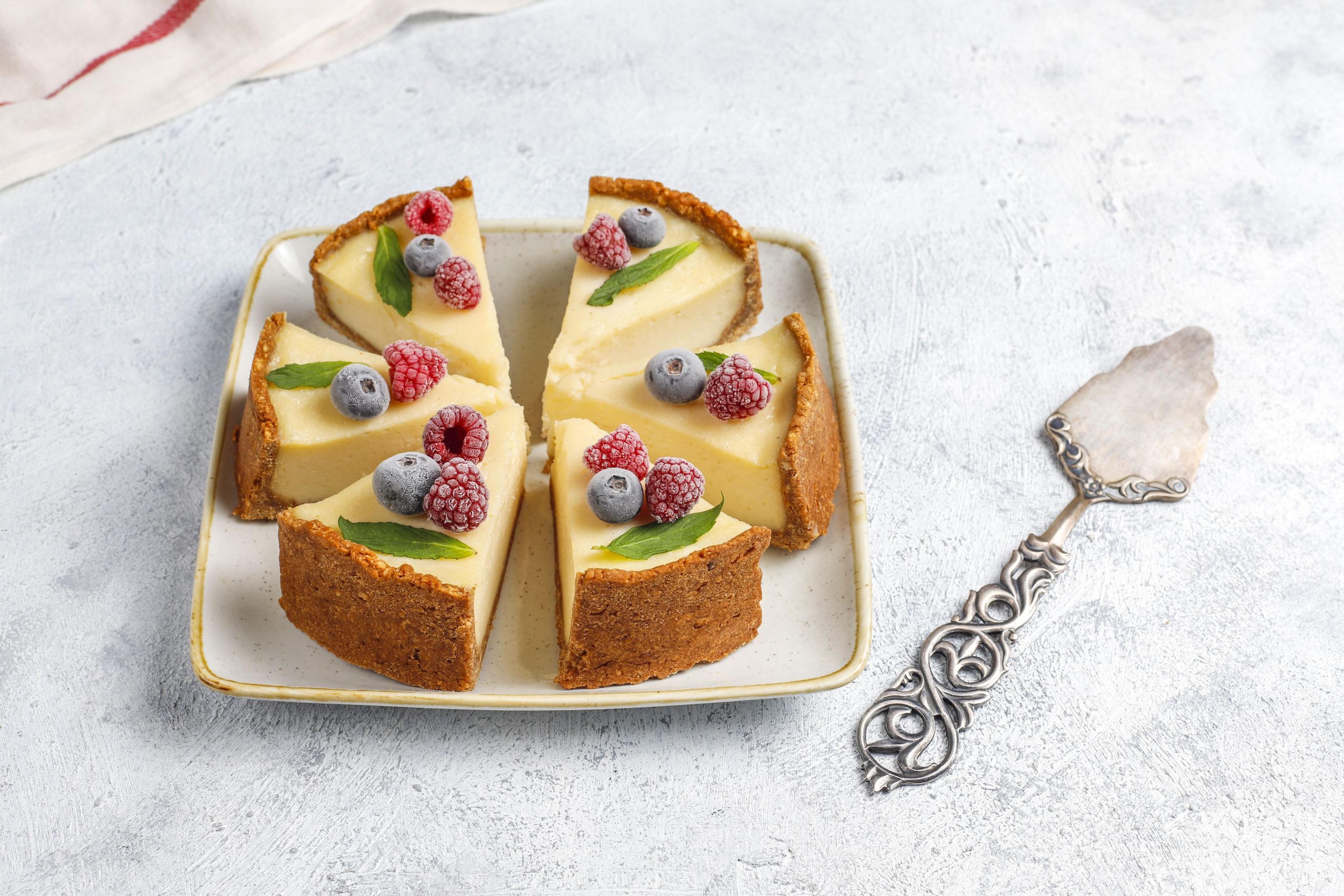 homemade newyork cheesecake with frozen berries mint healthy organic dessert top view scaled